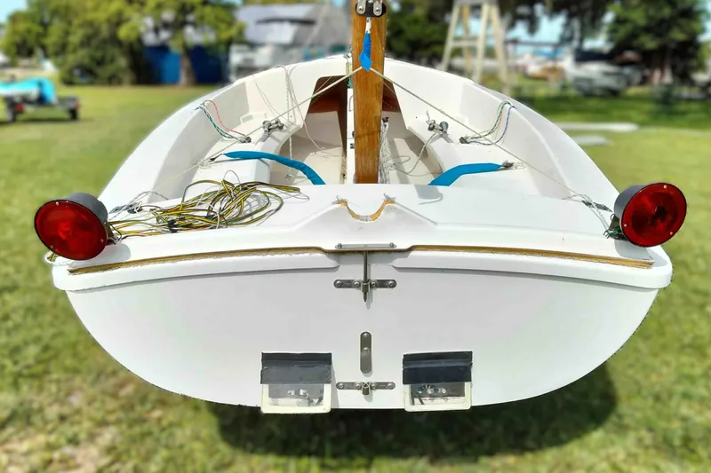 Slide: The Image of Rear view of a 2001 Rebel Mark IV sailboat on grass, showcasing its structure and rigging. - 20
