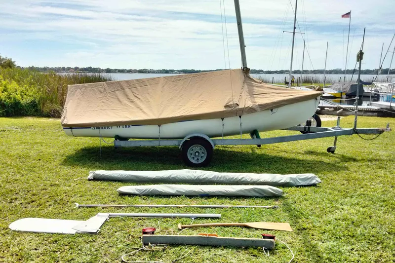 Slide: The Image of Sailboat on trailer with cover, surrounded by sailing equipment, Rebel Mark IV, 2001 model. - 22
