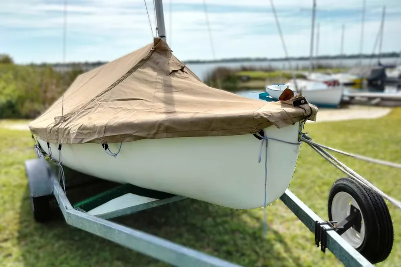 Slide: The Image of Covered Rebel Mark IV sailboat on trailer, grassy area, 2001 model. - 21
