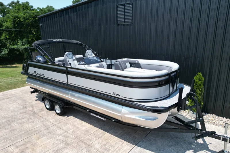 Slide: The Image of 2027 Viaggio Lago X-S 24 pontoon boat on trailer, parked outdoors. - 18
