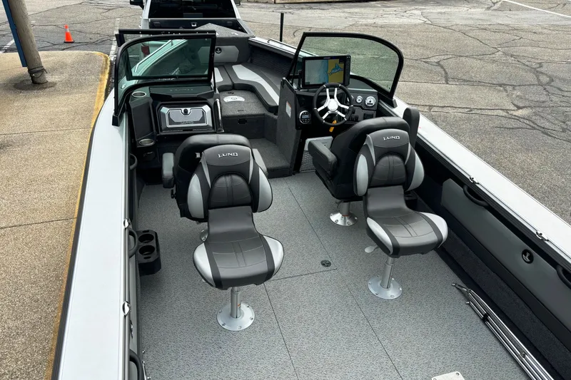 Slide: The Image of 2025 Lund 2275 Baron boat interior with modern seating and navigation system. - 18