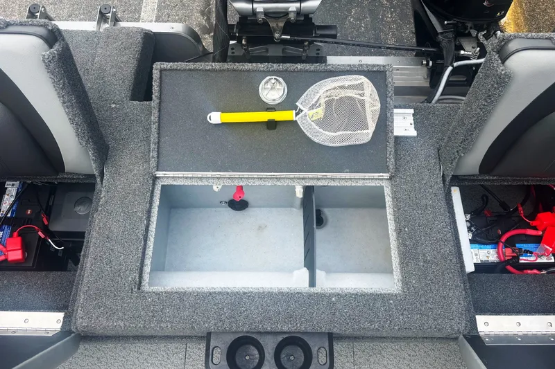 Slide: The Image of 2025 Lund 2275 Baron boat interior with storage compartments and fishing gear. - 17