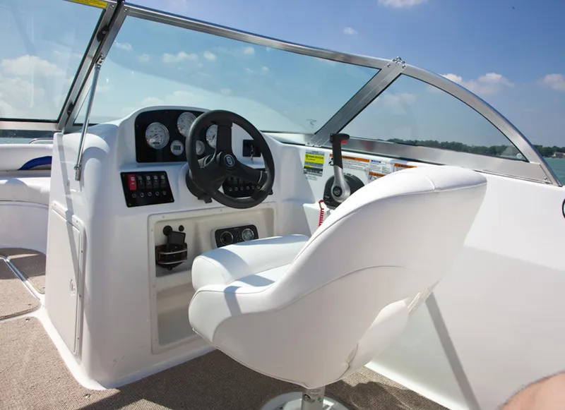 Slide: The Image of Manufacturer Provided Image: 2013 Hurricane SunDeck 187 OB boat interior with steering wheel and captain's chair. - 5