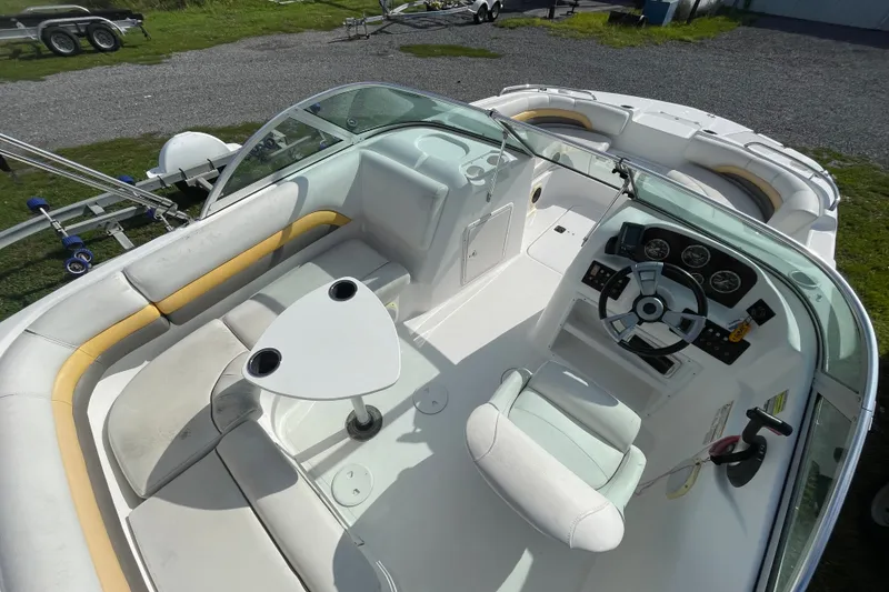 Slide: The Image of 2013 Hurricane SunDeck 187 OB boat interior with seating, steering wheel, and table. - 1