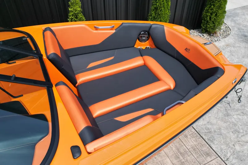 Slide: The Image of 2022 MasterCraft NXT24 boat interior with orange and black seating. - 18