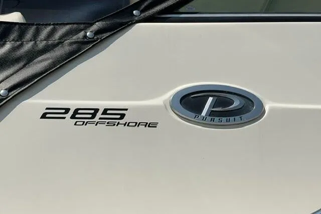 Slide: The Image of 2010 Pursuit OS 285 Offshore boat emblem and logo detail. - 13