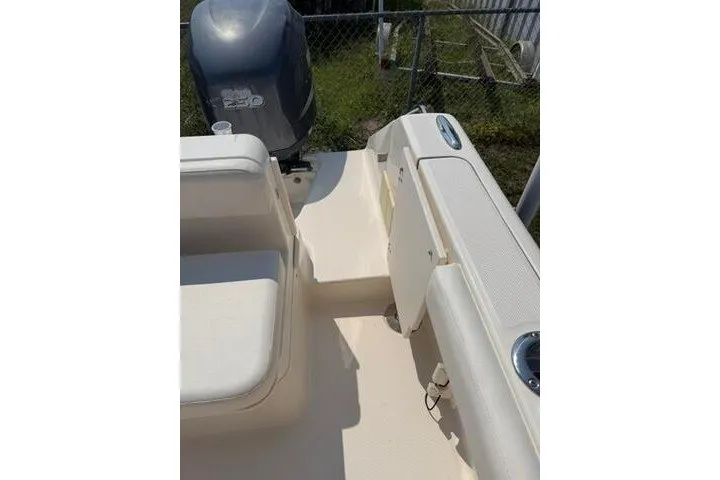 Slide: The Image of 2010 Pursuit OS 285 Offshore boat deck with seating and outboard motor. - 26