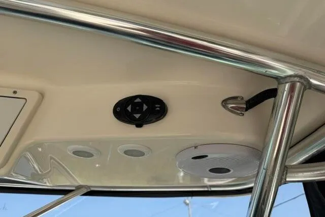 Slide: The Image of 2010 Pursuit OS 285 Offshore boat interior ceiling with control panel and speaker. - 46