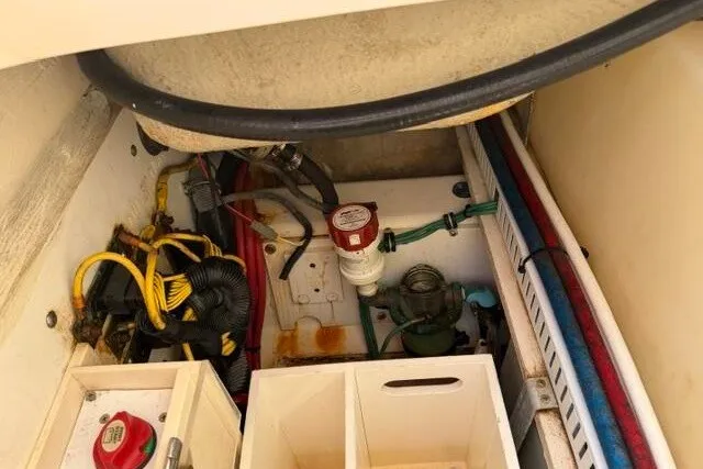 Slide: The Image of 2010 Pursuit OS 285 Offshore boat engine compartment with wiring and components. - 57