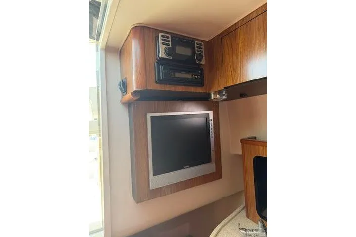 Slide: The Image of Interior of 2010 Pursuit OS 285 Offshore boat with TV and stereo system. - 65