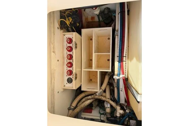 Slide: The Image of Electrical panel and wiring inside a 2010 Pursuit OS 285 Offshore boat. - 56