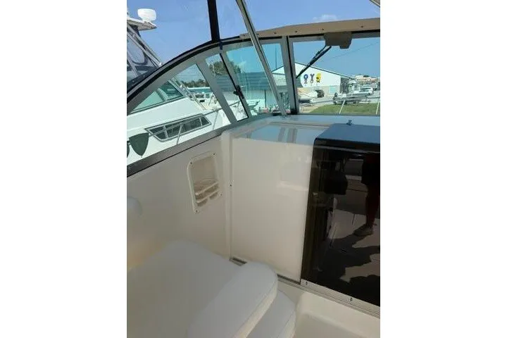 Slide: The Image of 2010 Pursuit OS 285 Offshore boat interior with seating and cabin view. - 39