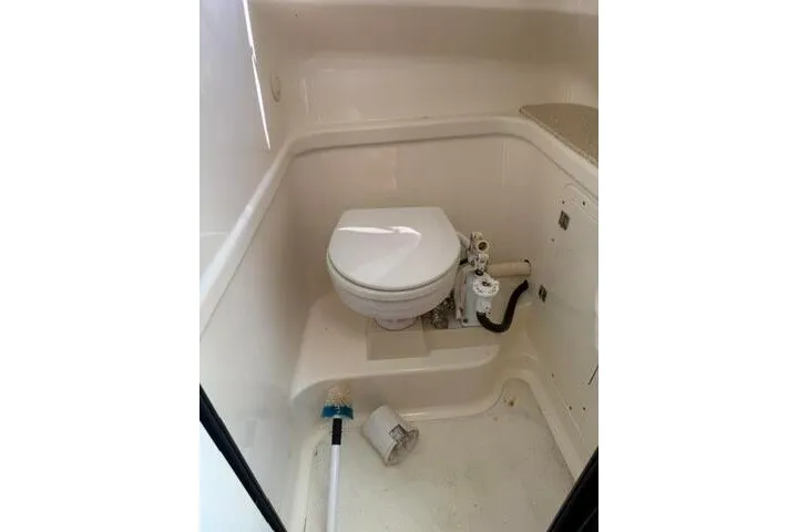 Slide: The Image of 2010 Pursuit OS 285 Offshore boat bathroom with compact marine toilet. - 68