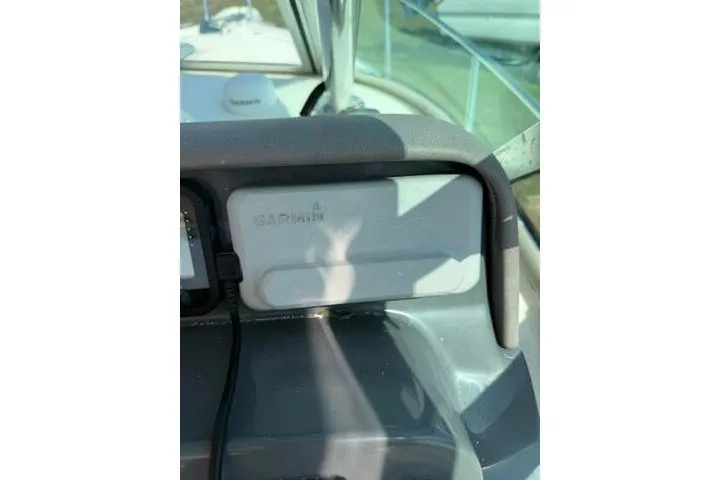 Slide: The Image of 2010 Pursuit OS 285 Offshore boat dashboard with Garmin device. - 47
