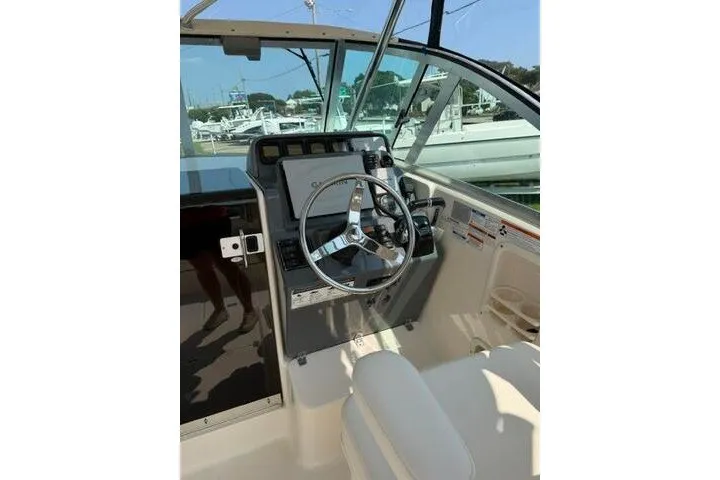 Slide: The Image of Helm of 2010 Pursuit OS 285 Offshore boat with steering wheel and controls. - 40