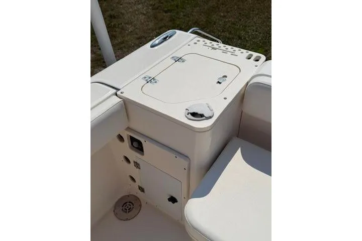 Slide: The Image of 2010 Pursuit OS 285 Offshore boat deck with storage compartment and seating. - 21