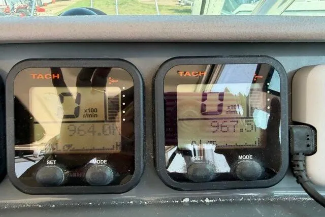 Slide: The Image of Dashboard of a 2010 Pursuit OS 285 Offshore boat showing tachometer readings. - 59