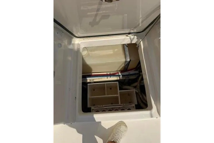 Slide: The Image of Open hatch on 2010 Pursuit OS 285 Offshore boat showing storage compartment. - 55
