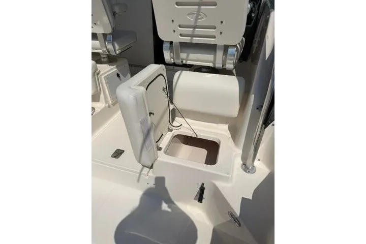 Slide: The Image of 2010 Pursuit OS 285 Offshore boat interior with open storage compartment. - 35