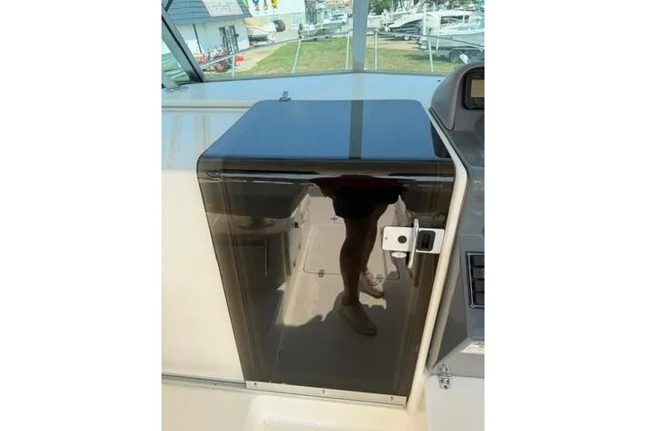 Slide: The Image of 2010 Pursuit OS 285 Offshore boat interior with reflective cabin door. - 44