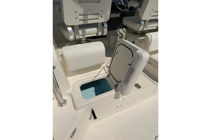 Slide: The Image of 2010 Pursuit OS 285 Offshore boat interior with open storage compartment. - 34