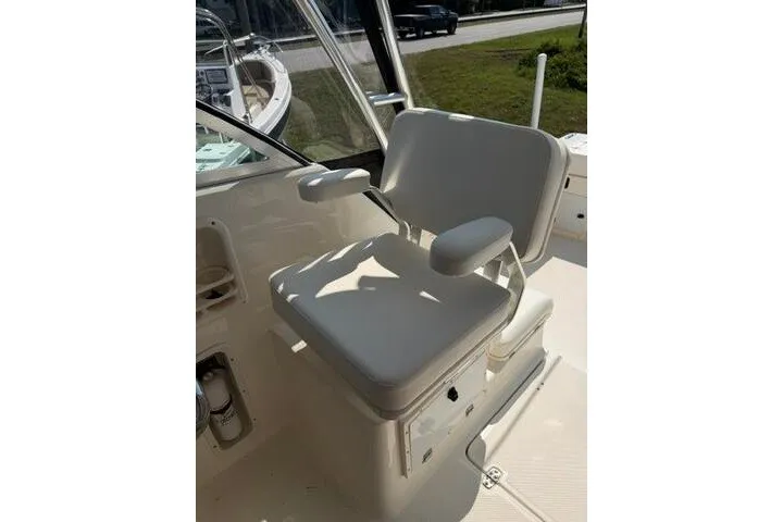 Slide: The Image of Captain's chair on 2010 Pursuit OS 285 Offshore boat, featuring cushioned seating and armrests. - 42
