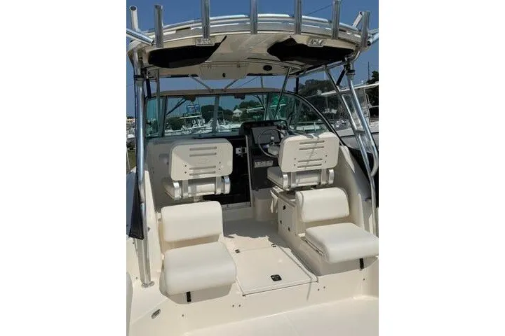 Slide: The Image of 2010 Pursuit OS 285 Offshore boat interior with dual seats and steering console. - 18