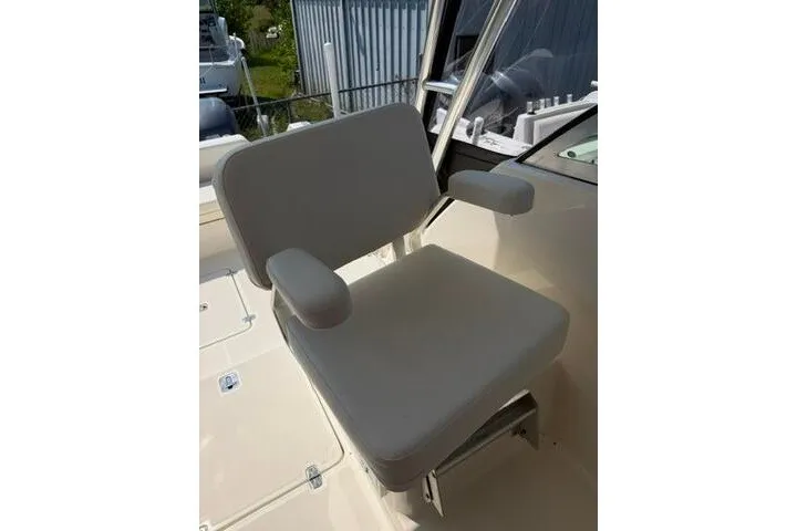Slide: The Image of Captain's chair on 2010 Pursuit OS 285 Offshore boat, featuring cushioned armrests and sturdy design. - 41