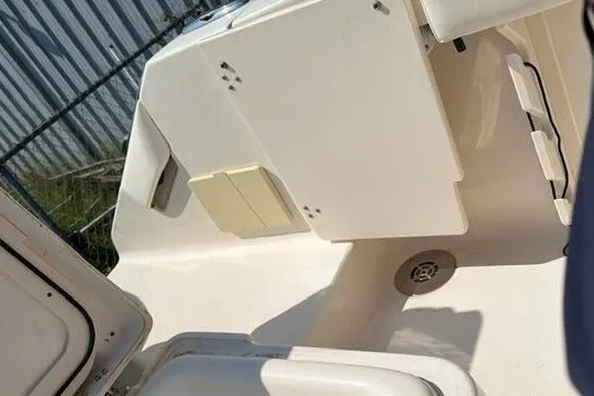 Slide: The Image of 2010 Pursuit OS 285 Offshore boat interior with storage compartments and drain. - 28