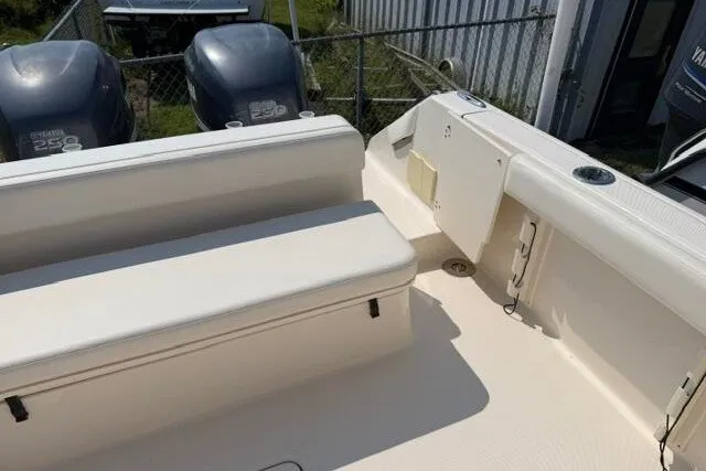 Slide: The Image of 2010 Pursuit OS 285 Offshore boat interior with seating and dual engines. - 25