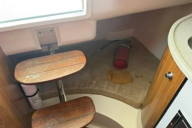 Slide: The Image of 2010 Pursuit OS 285 Offshore cabin interior with wooden steps and fire extinguisher. - 64