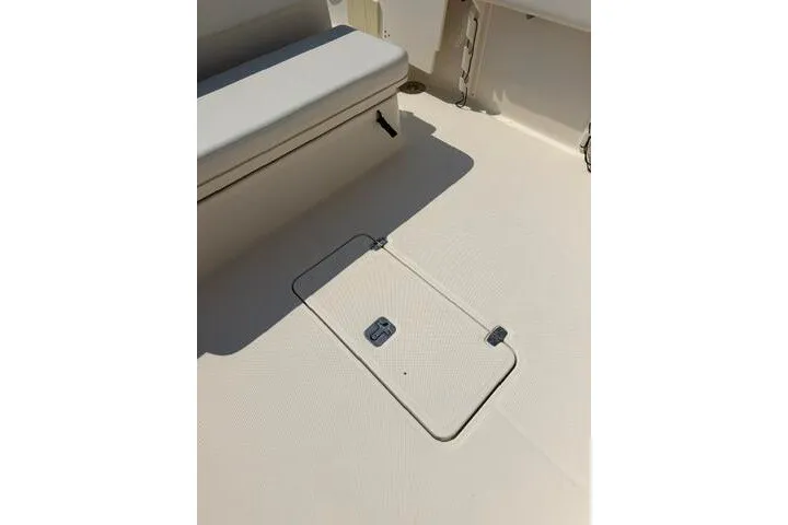 Slide: The Image of 2010 Pursuit OS 285 Offshore boat deck with storage hatch and seating. - 37