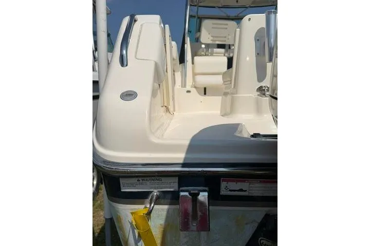Slide: The Image of 2010 Pursuit OS 285 Offshore boat, rear view, showcasing seating and deck details. - 16