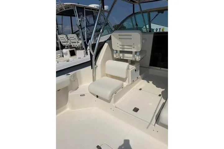 Slide: The Image of 2010 Pursuit OS 285 Offshore boat interior with seating and helm station. - 31