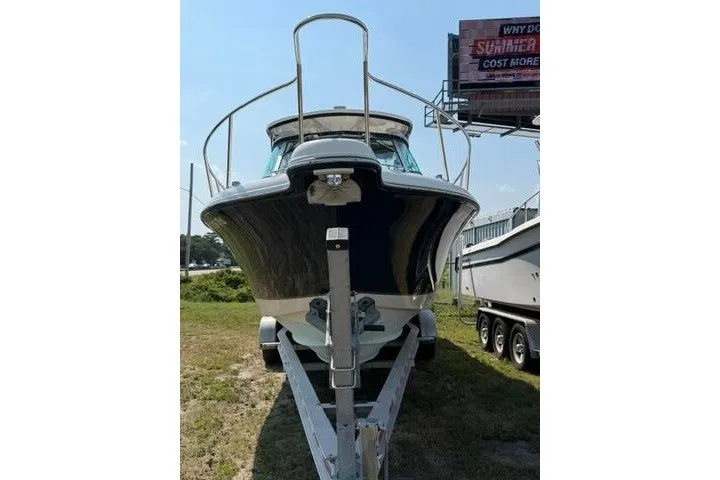 Slide: The Image of 2010 Pursuit OS 285 Offshore boat on trailer, front view, outdoors. - 14