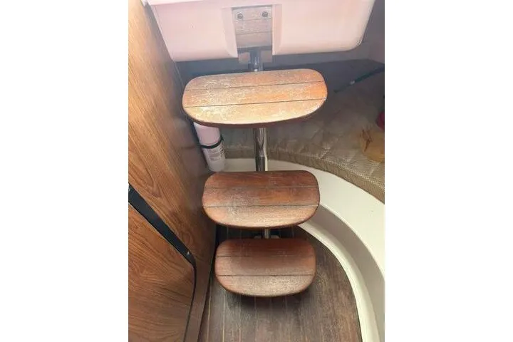 Slide: The Image of Wooden steps inside a 2010 Pursuit OS 285 Offshore boat cabin. - 71