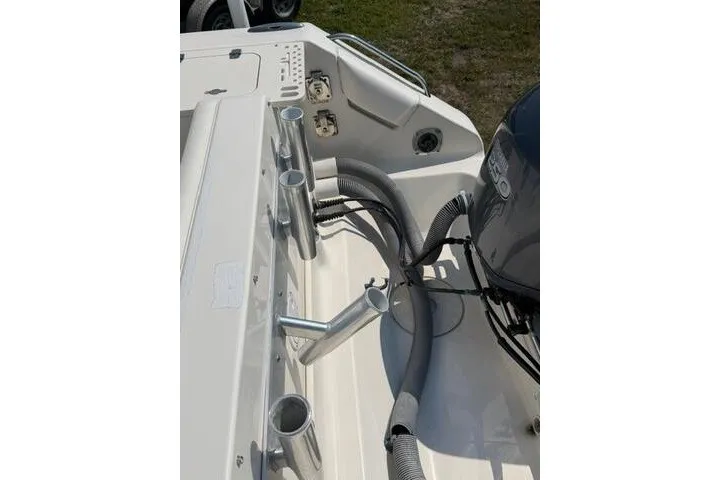 Slide: The Image of 2010 Pursuit OS 285 Offshore boat deck with rod holders and engine view. - 19