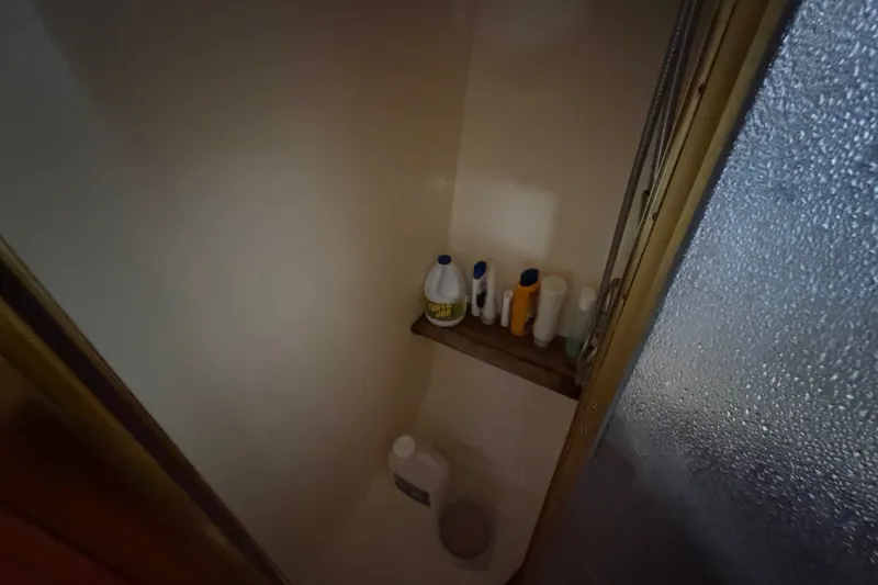 Slide: The Image of Shower area with toiletries on a shelf in a 1989 Egg Harbor 41 Convertible. - 31
