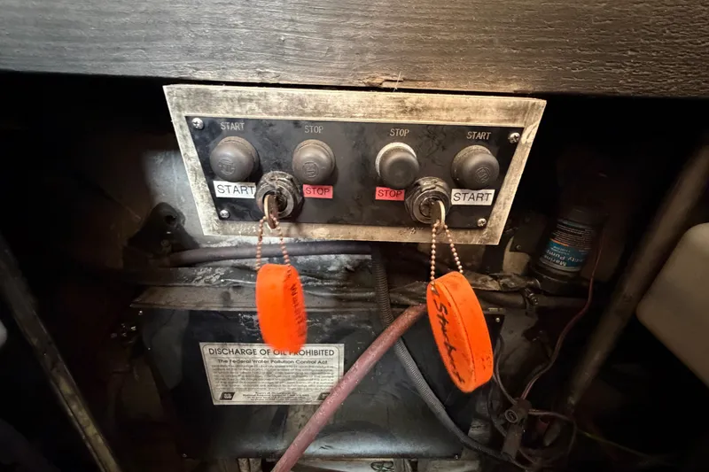 Slide: The Image of Control panel of a 1989 Egg Harbor 41 Convertible boat with start and stop buttons. - 53