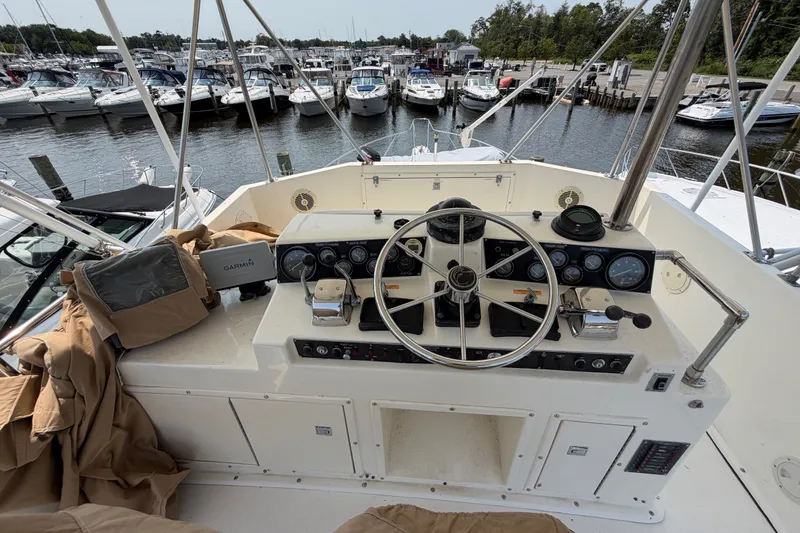 Slide: The Image of Cockpit of 1989 Egg Harbor 41 Convertible yacht with steering wheel and navigation equipment. - 35