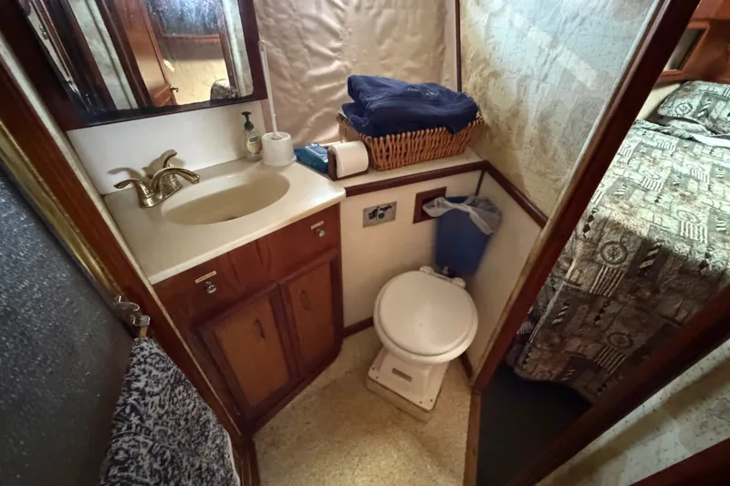 Slide: The Image of 1989 Egg Harbor 41 Convertible yacht bathroom with sink, toilet, and storage. - 30