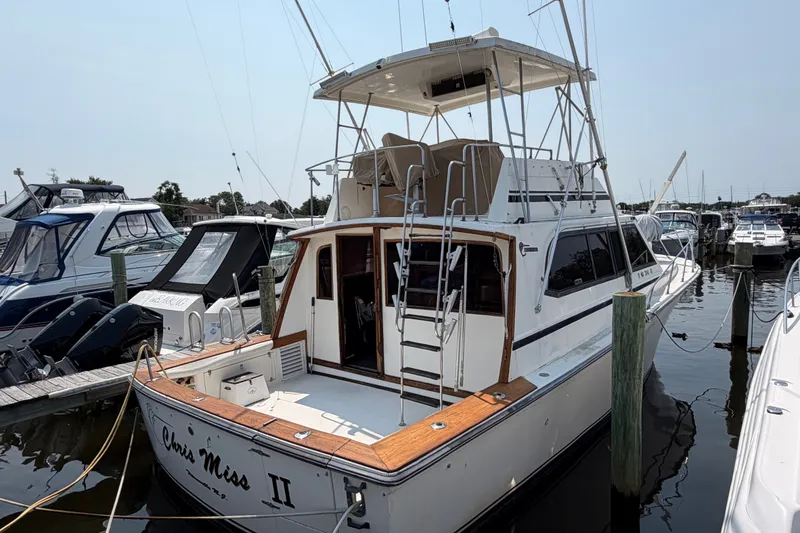 Slide: The Image of 1989 Egg Harbor 41 Convertible yacht docked at marina, featuring spacious deck and flybridge. - 3