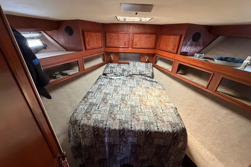 Slide: The Image of Cozy cabin interior of 1989 Egg Harbor 41 Convertible yacht with patterned bedding. - 25