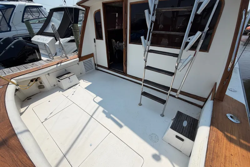 Slide: The Image of 1989 Egg Harbor 41 Convertible boat deck with ladder and storage compartments. - 5