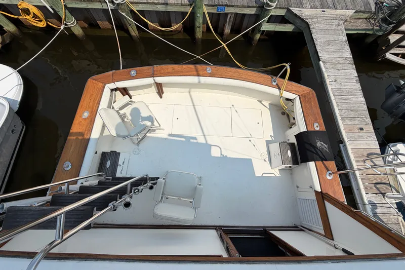 Slide: The Image of 1989 Egg Harbor 41 Convertible boat deck with seating, docked at marina. - 33