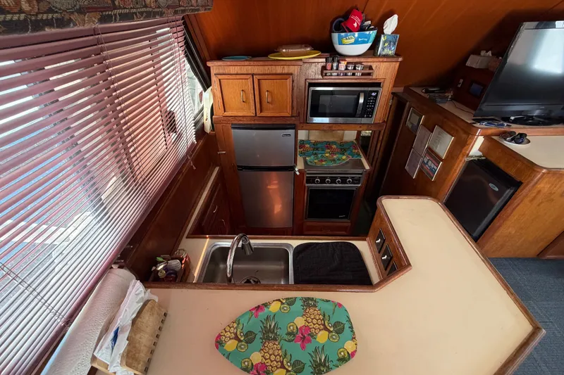Slide: The Image of Interior of 1989 Egg Harbor 41 Convertible yacht kitchen with appliances and colorful decor. - 15