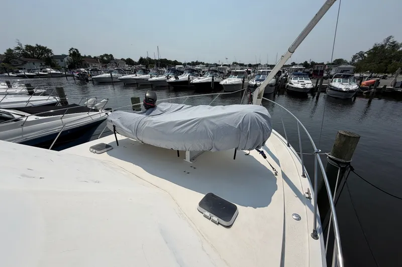 Slide: The Image of 1989 Egg Harbor 41 Convertible yacht docked at marina with covered equipment on deck. - 47