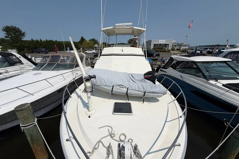 Slide: The Image of 1989 Egg Harbor 41 Convertible yacht docked at marina, surrounded by other boats. - 46