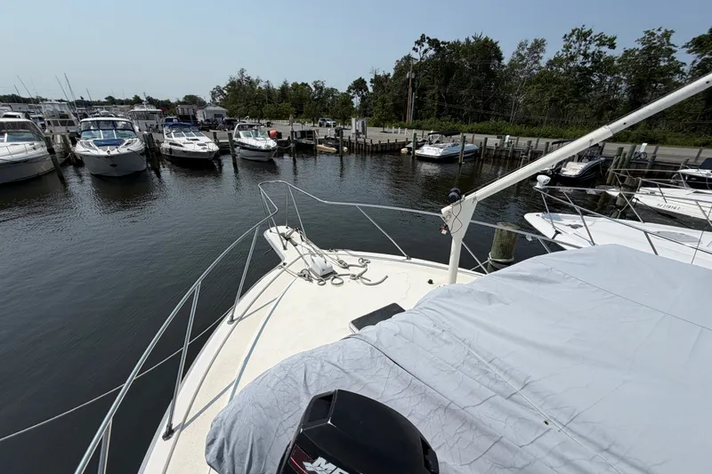 Slide: The Image of 1989 Egg Harbor 41 Convertible yacht docked at a marina with other boats. - 41