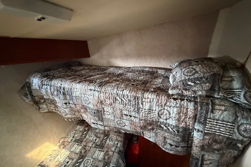 Slide: The Image of Interior cabin of 1989 Egg Harbor 41 Convertible with patterned bedding. - 23
